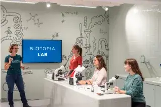 Besucherinnen beim kostenlosen Mitmachprogramm vor Mikroskopen im Biotopia Lab