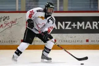 Kathrin Lehmann as an ice-hockey player controlling the puck with a stick