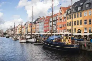 Colorful houses and moored boats in Nyhavn in Copenhagen